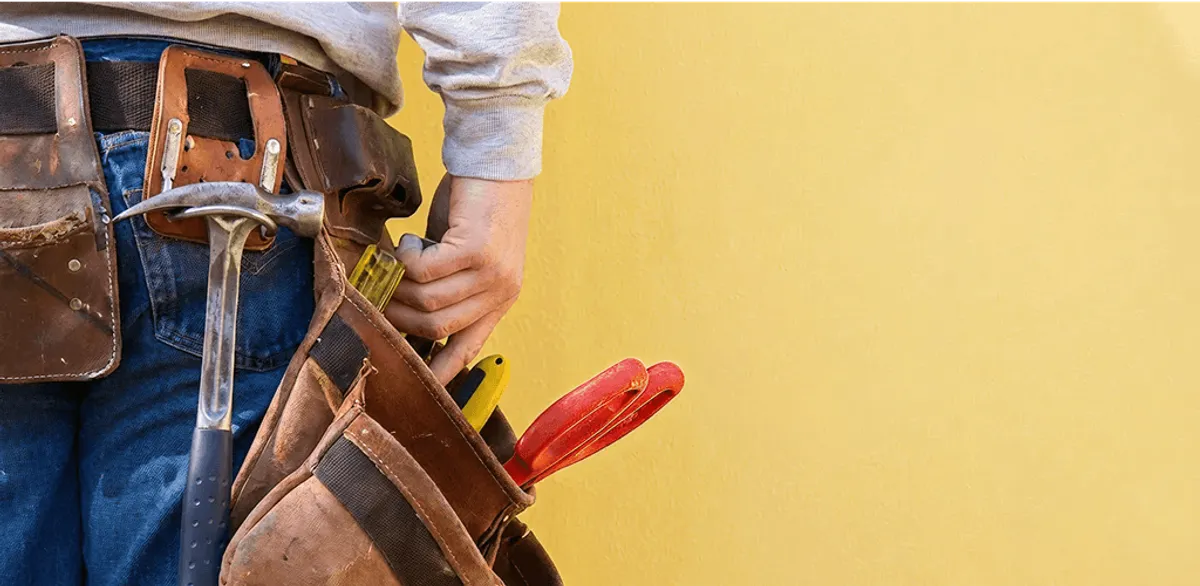 Handyman with tool belt ready for home repairs and maintenance in Jersey City, NJ